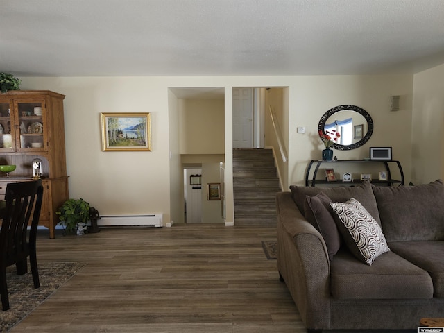 living area with stairway, dark wood-style flooring, and baseboard heating