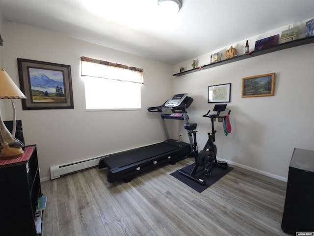 workout room with baseboards and wood finished floors