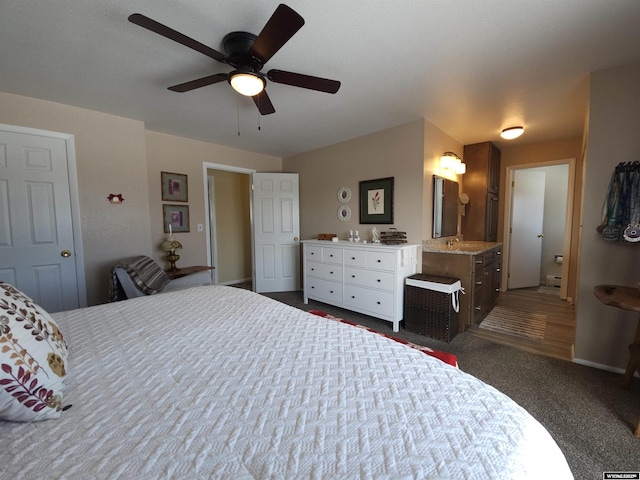 bedroom with dark colored carpet, connected bathroom, baseboards, and a ceiling fan