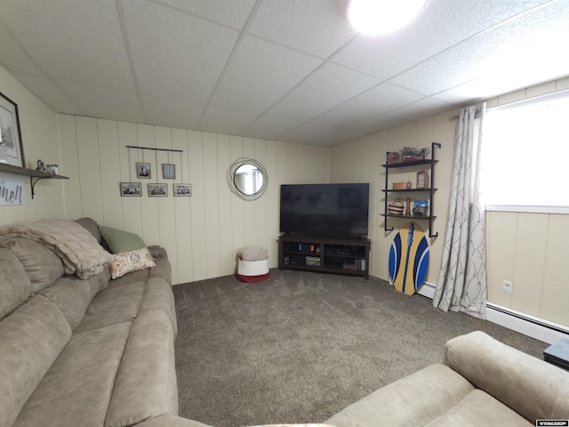 living area featuring a baseboard heating unit, a paneled ceiling, and carpet