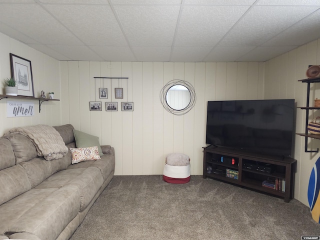 living room featuring a paneled ceiling and carpet flooring