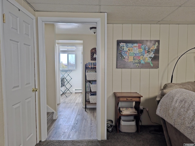 interior space with wood finished floors and baseboard heating