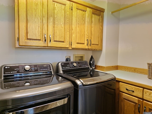 laundry room featuring cabinet space and washing machine and dryer