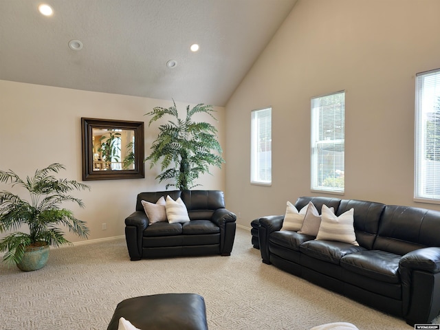 carpeted living area with recessed lighting, high vaulted ceiling, and baseboards