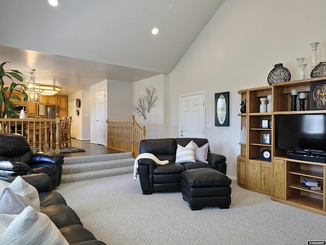 living room with high vaulted ceiling, recessed lighting, an inviting chandelier, carpet flooring, and baseboards