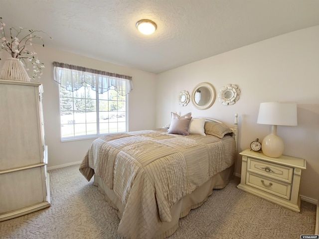 bedroom featuring baseboards and light colored carpet