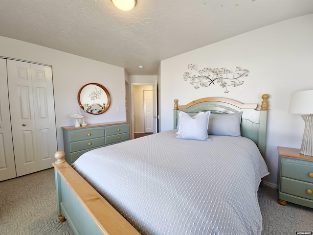 carpeted bedroom with a closet and a textured ceiling