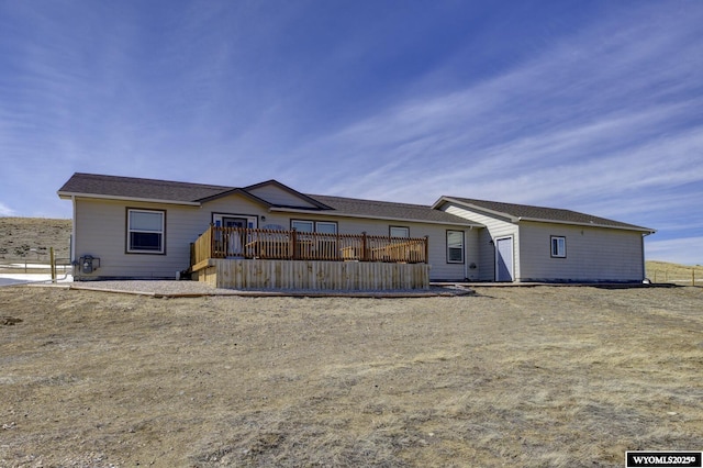 back of house featuring a deck