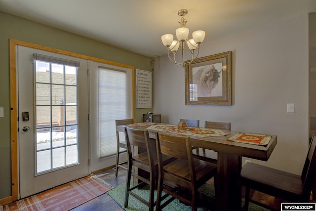 dining space with an inviting chandelier and wood finished floors