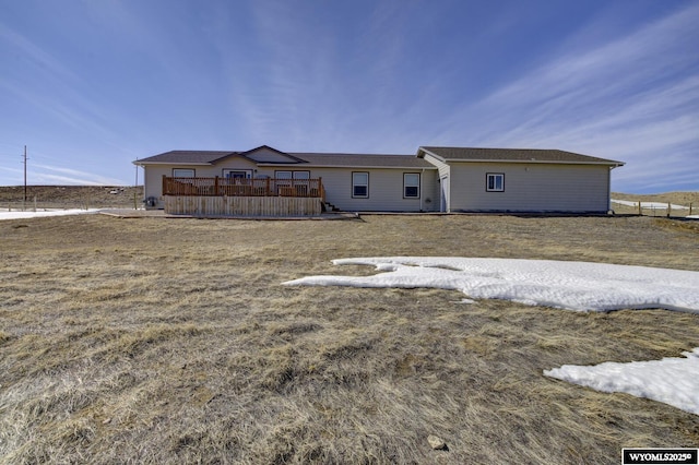 rear view of house with a wooden deck