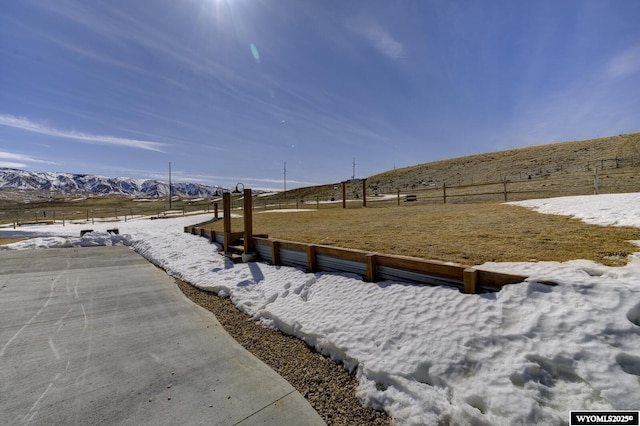 view of yard featuring a mountain view and fence