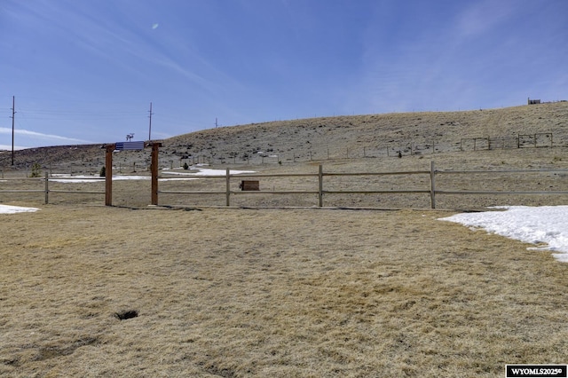 view of yard featuring a rural view and fence