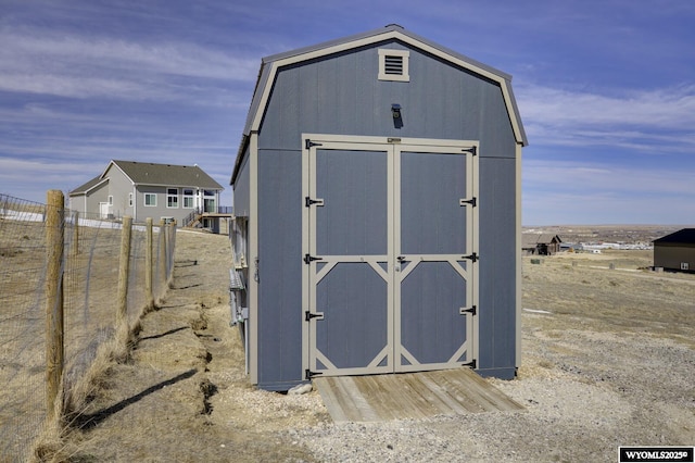 view of shed with fence