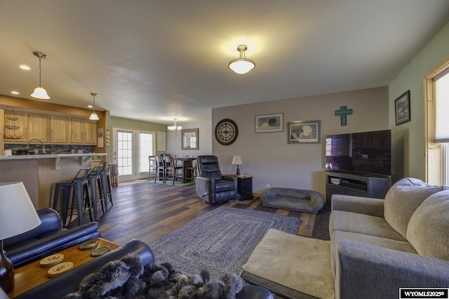 living room with dark wood finished floors, a chandelier, and recessed lighting