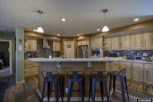 kitchen featuring dark wood finished floors, a kitchen island with sink, stainless steel appliances, wall chimney exhaust hood, and backsplash