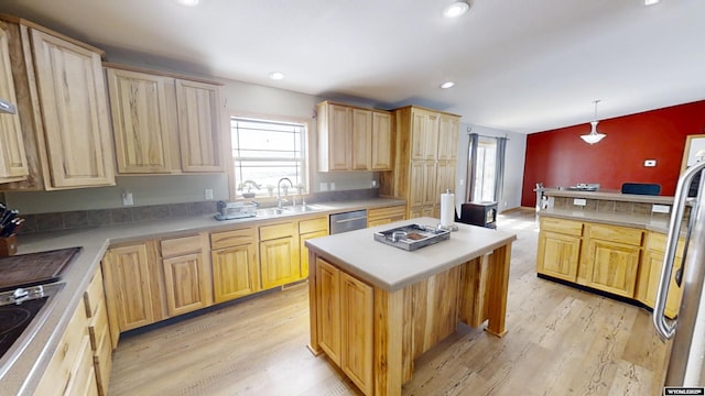 kitchen with light brown cabinets, light wood finished floors, a sink, stainless steel dishwasher, and fridge