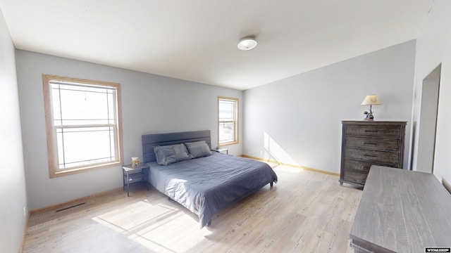 bedroom with light wood-style flooring and baseboards