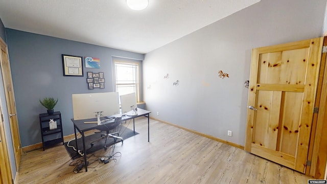 home office featuring light wood-style flooring and baseboards