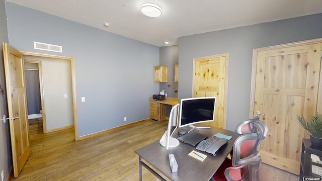 office featuring light wood-style floors, visible vents, and baseboards