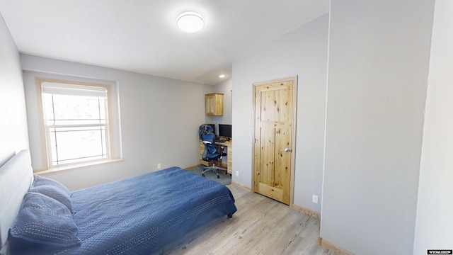 bedroom featuring baseboards and light wood finished floors