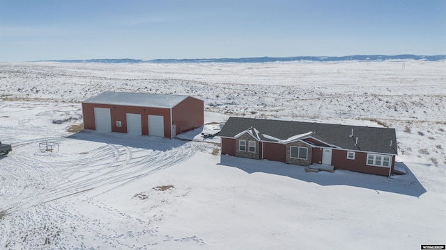 snowy aerial view with a mountain view