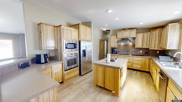 kitchen featuring a sink, under cabinet range hood, light brown cabinetry, and stainless steel appliances