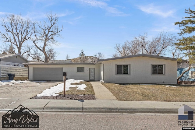 view of front of property with concrete driveway, an attached garage, and fence