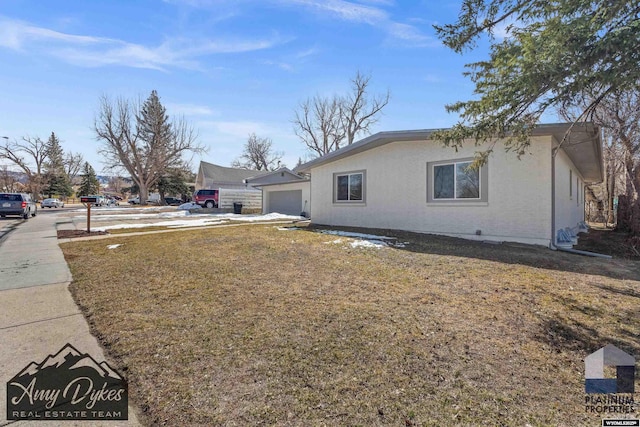 exterior space with a garage and stucco siding