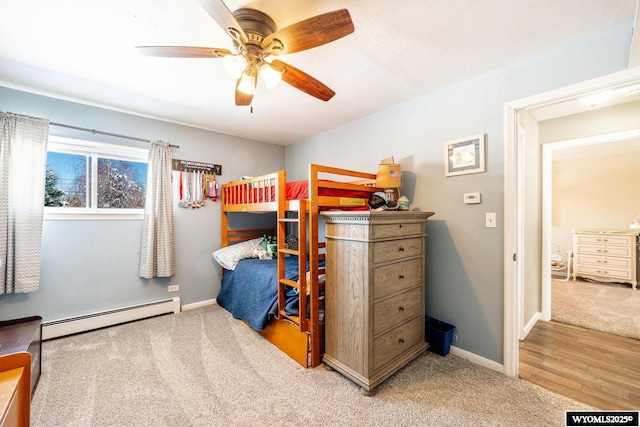 carpeted bedroom featuring a ceiling fan, baseboards, and baseboard heating