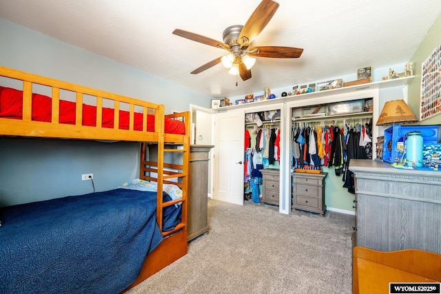 bedroom with carpet flooring, multiple closets, and ceiling fan