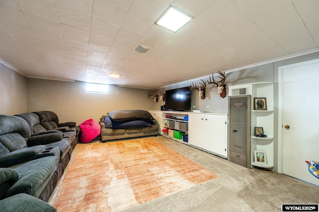 carpeted living area featuring visible vents and ornamental molding