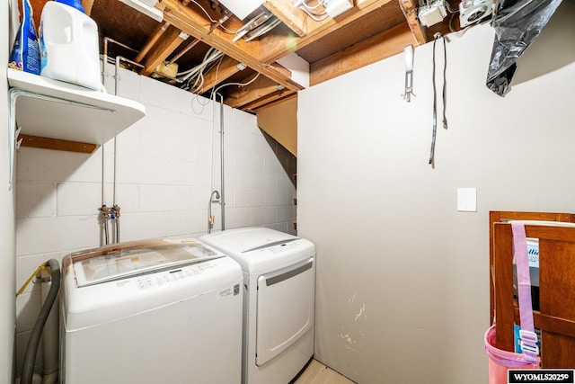 clothes washing area with laundry area and washer and clothes dryer