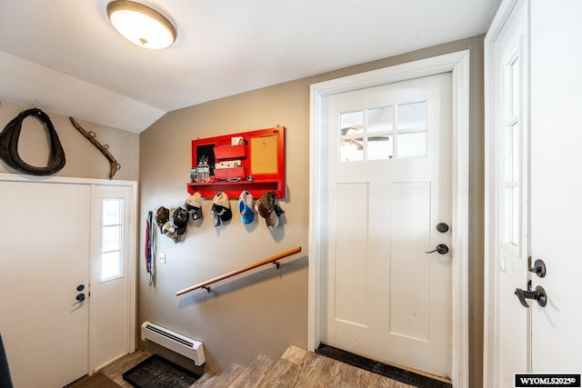 entrance foyer featuring a baseboard heating unit and lofted ceiling