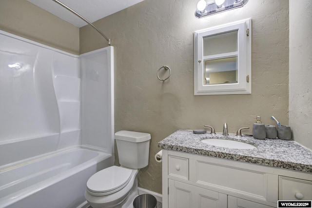 bathroom featuring bathing tub / shower combination, toilet, vanity, and a textured wall