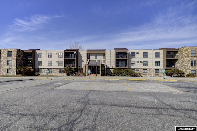 view of building exterior with uncovered parking