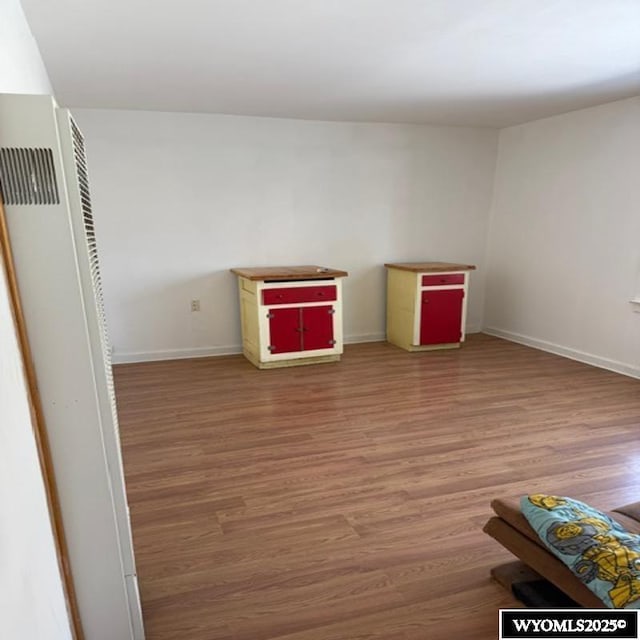 interior space featuring light wood-type flooring and baseboards