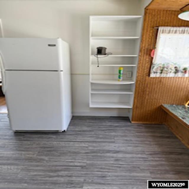 interior space featuring freestanding refrigerator and wood finished floors