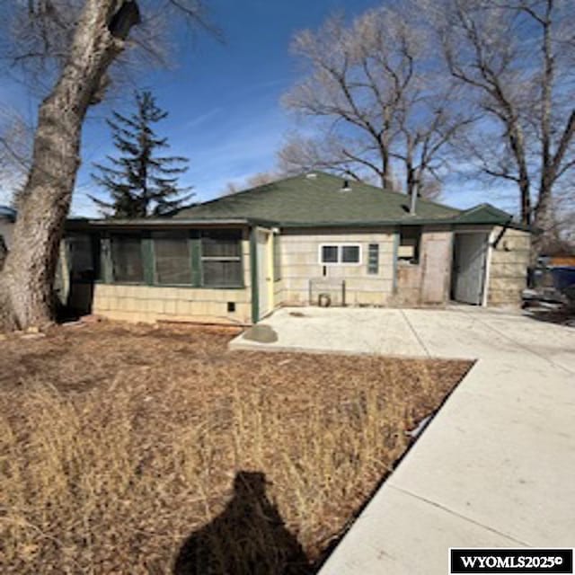 view of front of property featuring a patio, a sunroom, and driveway