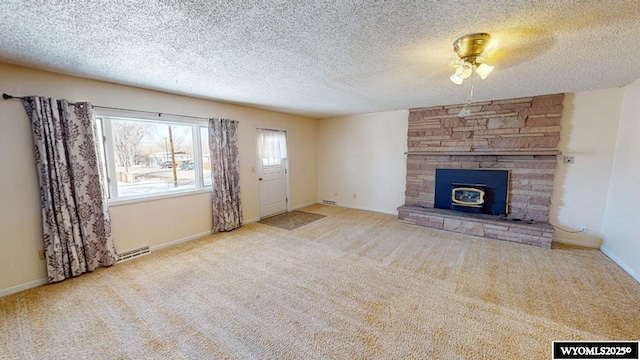 unfurnished living room featuring baseboards, a textured ceiling, and carpet flooring