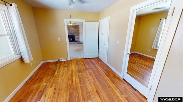 interior space featuring light wood-style flooring, visible vents, and baseboards