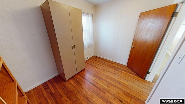 bedroom with light wood-style flooring and baseboards