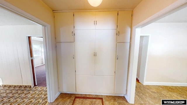 hallway featuring baseboards