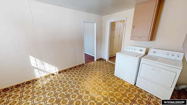 laundry area featuring laundry area, washing machine and dryer, and light floors