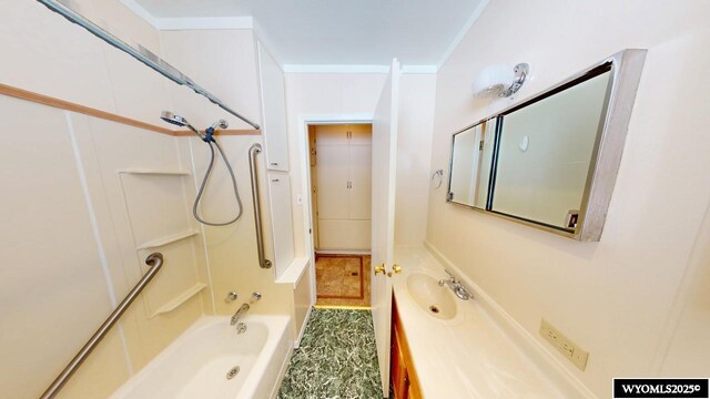 bathroom featuring bathing tub / shower combination, ornamental molding, and vanity