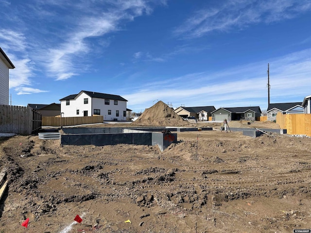 view of yard featuring a residential view and fence