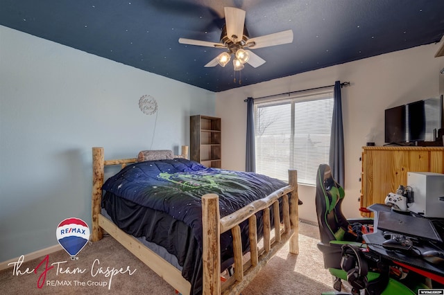 carpeted bedroom featuring baseboards and ceiling fan