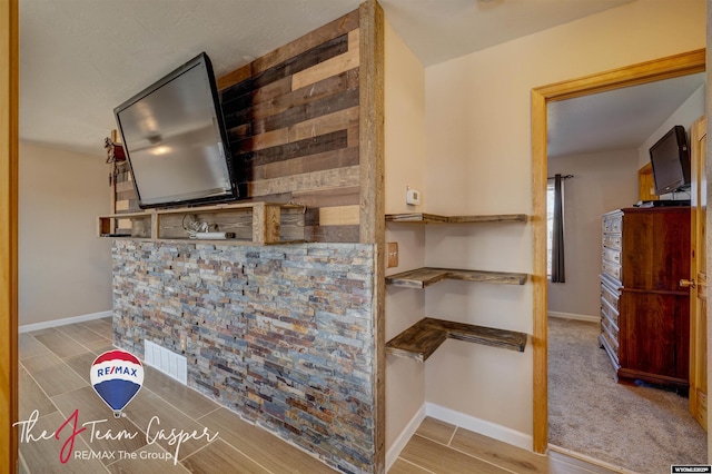 interior space featuring baseboards and wood tiled floor