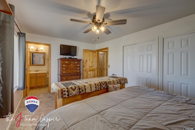 bedroom featuring light colored carpet, connected bathroom, and ceiling fan