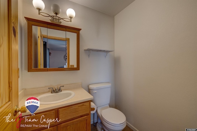 bathroom with toilet and vanity