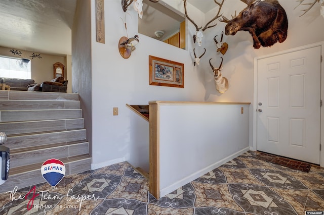 interior space with stone finish flooring and baseboards